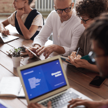 photo-of-people-working-near-brown-wooden-table-3184162